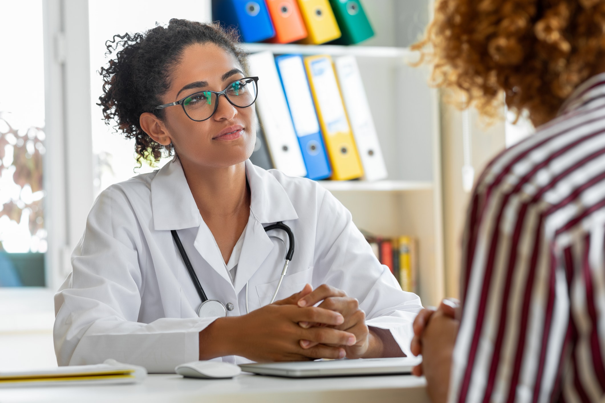 doctor listening to her patient