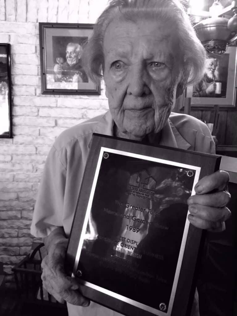 104 year old woman holding up a photo